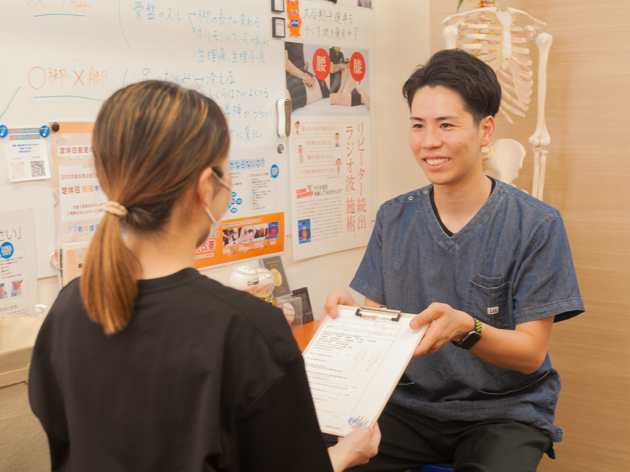 お身体のお悩みを笑顔で伺う問診の様子